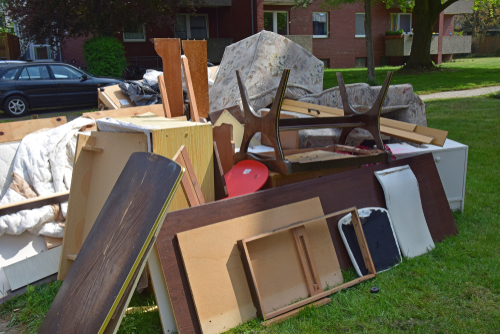 Furniture dumped on the side of pavement.